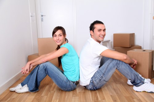 Trained movers handling furniture with care inside a removal van