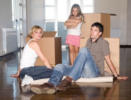 Packed moving boxes and furniture ready for transport in a South Kensington flat